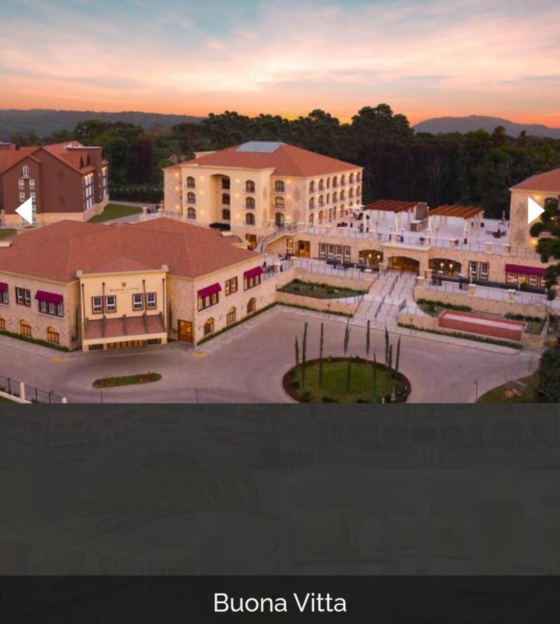 Buona Vitta Gramado Resort & Spa By Gramado Parks Екстер'єр фото The image shows a large, modern building complex, likely a hotel or resort. The architecture features a combination of traditional and contemporary design elements. Surrounding the main building are landscaped areas, including trees and green spaces,