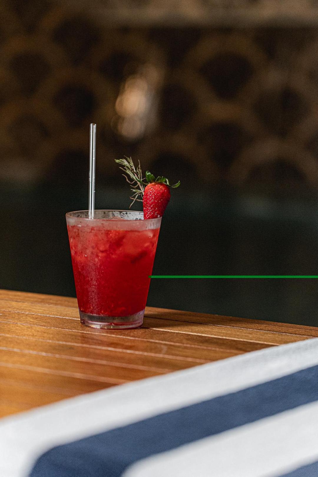 Buona Vitta Gramado Resort & Spa By Gramado Parks Екстер'єр фото The photo shows a refreshing cocktail served in a transparent glass. The drink is vibrant red, suggesting it may be made with strawberries or a similar fruit. It features a straw and a garnish of a fresh strawberry on the rim of the glass, along with